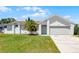 A well-maintained home exterior, showcasing a lush green lawn and mature landscaping at 996 Big Oaks Dr, Oviedo, FL 32765