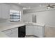 Modern kitchen featuring white countertops and cabinets, stainless steel sink, and tiled floors at 996 Big Oaks Dr, Oviedo, FL 32765
