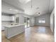 Bright, open living room with tile floors, modern kitchen, and sliding glass doors to the pool at 996 Big Oaks Dr, Oviedo, FL 32765