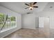 Spacious living room with tiled floors, high ceilings, ceiling fan and natural light from the window at 996 Big Oaks Dr, Oviedo, FL 32765