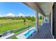 Balcony overlooking a pool and outdoor grill with a view of the lawn at 16825 Bolsena Dr, Montverde, FL 34756