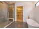 Elegant bathroom featuring a glass shower and soaker tub with brass fixtures, adjacent to the walk-in closet at 16825 Bolsena Dr, Montverde, FL 34756