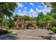 Elegant community entrance with stone gatehouse, water fountain, and meticulously maintained landscaping at 16825 Bolsena Dr, Montverde, FL 34756