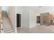 Bright foyer with modern door, leading to stairs, living area with fireplace and wine cellar at 16825 Bolsena Dr, Montverde, FL 34756