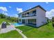 This is the rear exterior of a modern home with a pool and sleek design at 16825 Bolsena Dr, Montverde, FL 34756