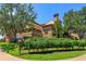Luxurious community clubhouse featuring stone architecture and lush landscaping on a bright, sunny day at 16825 Bolsena Dr, Montverde, FL 34756