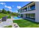Rear exterior of modern house, showing pool and patio at 16825 Bolsena Dr, Montverde, FL 34756