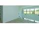 Bright hallway with wood floors features a wall of windows with a nice view of the outdoors at 16825 Bolsena Dr, Montverde, FL 34756
