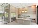 Modern kitchen with island, stainless steel appliances, and glass enclosed wine cellar at 16825 Bolsena Dr, Montverde, FL 34756