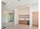 Open living area with wine cellar, mini-bar, and expansive sliding glass doors with access to backyard at 16825 Bolsena Dr, Montverde, FL 34756