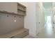 Bright mudroom features custom built-ins with drawers, hooks, and shelves for storage, with easy access to the home at 16825 Bolsena Dr, Montverde, FL 34756