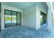 Covered patio with stone flooring and sliding glass doors for indoor/outdoor living at 16825 Bolsena Dr, Montverde, FL 34756