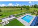 Swimming pool with an outdoor kitchen and a wide view of the lawn at 16825 Bolsena Dr, Montverde, FL 34756