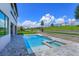 Backyard view of the pool, spa, and landscaped yard at 16825 Bolsena Dr, Montverde, FL 34756