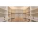 Spacious walk-in closet with custom shelving and drawers for optimal organization at 16825 Bolsena Dr, Montverde, FL 34756