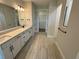 Bathroom featuring double vanity, tile floors, and a walk-in closet at 2592 Pine Preserve Ct, St Cloud, FL 34771