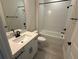 Bathroom featuring single vanity with black hardware and a bathtub at 2592 Pine Preserve Ct, St Cloud, FL 34771