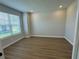 Bright bedroom features wood-look floors, neutral paint, and large window at 2592 Pine Preserve Ct, St Cloud, FL 34771