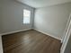 Empty bedroom features wood-look floors, neutral paint, and backyard views at 2592 Pine Preserve Ct, St Cloud, FL 34771