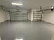 Spacious, clean garage with epoxy flooring and two garage door openers at 2592 Pine Preserve Ct, St Cloud, FL 34771