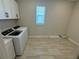 Bright laundry room with new appliances, tile floors, and natural light at 2592 Pine Preserve Ct, St Cloud, FL 34771