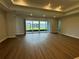 Spacious living room with sliding glass doors to the backyard and wood-look floors at 2592 Pine Preserve Ct, St Cloud, FL 34771