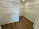Spacious walk-in closet with wood-look floors and metal shelving at 2592 Pine Preserve Ct, St Cloud, FL 34771
