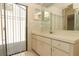 Bathroom featuring a vanity, ample counter space, and a window leading to the outdoor patio at 406 Red Coat Ln, Orlando, FL 32825