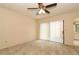 Spacious bedroom features neutral walls, plush carpeting, and a sliding glass door for natural light at 406 Red Coat Ln, Orlando, FL 32825