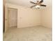 Spacious bedroom with carpet, a ceiling fan, and access to a walk-in closet at 406 Red Coat Ln, Orlando, FL 32825