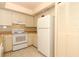 Functional kitchen featuring white appliances and ample cabinet space at 406 Red Coat Ln, Orlando, FL 32825