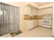 Bright kitchen with white appliances, and a sliding glass door to the backyard at 406 Red Coat Ln, Orlando, FL 32825