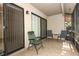 Relaxing covered patio area with tiled flooring and comfortable seating, perfect for enjoying the outdoors at 406 Red Coat Ln, Orlando, FL 32825