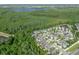 Breathtaking aerial view of a residential area near a lake, surrounded by verdant greenery and a clear blue sky at 8778 Peachtree Park Ct, Windermere, FL 34786