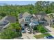 Beautiful aerial view of a two-story home with a well-manicured yard, complemented by lush trees and two cars in the driveway at 8778 Peachtree Park Ct, Windermere, FL 34786