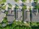 Birds-eye view of a home with a manicured lawn and driveway, showing its position within a well-maintained neighborhood at 8778 Peachtree Park Ct, Windermere, FL 34786