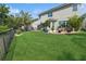 The large backyard showcases a well-maintained lawn, a black fence, and an attractive garden for outdoor enjoyment at 8778 Peachtree Park Ct, Windermere, FL 34786
