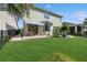 Spacious backyard with lush lawn, patio, and beautiful landscaping around the perimeter at 8778 Peachtree Park Ct, Windermere, FL 34786