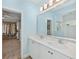 Bathroom with double sink vanity and walk in closet at 8778 Peachtree Park Ct, Windermere, FL 34786