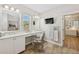 Inviting bathroom area with well-lit double vanity, walk-in shower, and a chair for comfort at 8778 Peachtree Park Ct, Windermere, FL 34786