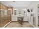 Elegant bathroom featuring a luxurious walk-in shower, dual vanity sinks and modern lighting at 8778 Peachtree Park Ct, Windermere, FL 34786