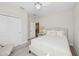 Cozy bedroom with a neutral palette, plush carpeting, and a convenient closet at 8778 Peachtree Park Ct, Windermere, FL 34786