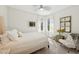 Bright bedroom features a cozy bed, light-colored carpet, and a large window at 8778 Peachtree Park Ct, Windermere, FL 34786