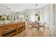 Living room with wood floors, dining area with natural lighting, and modern furniture at 8778 Peachtree Park Ct, Windermere, FL 34786