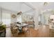 Bright dining room with a rustic wood table, stylish chairs, and an open view to the living room at 8778 Peachtree Park Ct, Windermere, FL 34786