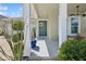Charming front porch with potted plants and a welcoming wreath on the teal front door at 8778 Peachtree Park Ct, Windermere, FL 34786