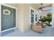 Inviting covered porch with comfortable seating and a stylish ceiling fan at 8778 Peachtree Park Ct, Windermere, FL 34786