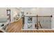 Hallway with wood floors, decorative railing, and views of other rooms at 8778 Peachtree Park Ct, Windermere, FL 34786