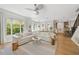 Open floor plan living room with large sofa, decorative touches, and a view into the kitchen at 8778 Peachtree Park Ct, Windermere, FL 34786