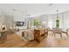 Bright living room with wood floors, modern furnishings, and large windows with sheer curtains at 8778 Peachtree Park Ct, Windermere, FL 34786